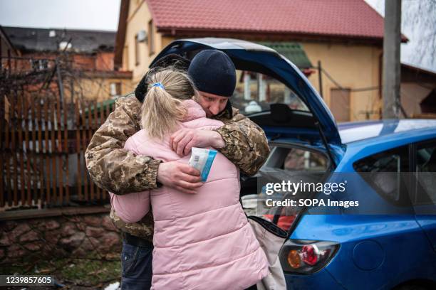 Man hugs a woman outside an apartment damaged by a shelling attack in Borodyanka, a town in Kyiv Oblast, from which occupying Russian troops recently...