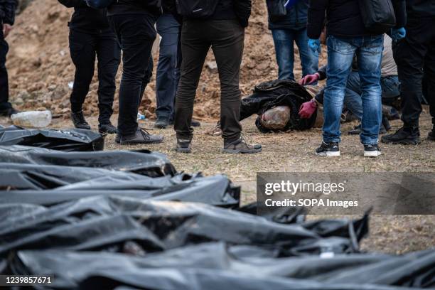 Image depicts death The authorities inspect bodies exhumed from a mass grave for possible war crimes in Bucha, a town in Kyiv Oblast, from which...