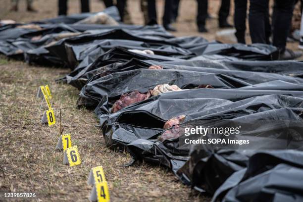 Image depicts death The authorities inspect bodies exhumed from a mass grave for possible war crimes in Bucha, a town in Kyiv Oblast, from which...
