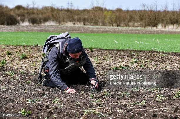Farmer wears a bulletproof vest during crop sowing which takes place 30 km from the front line, Zaporizhzhia Region, southeastern Ukraine.