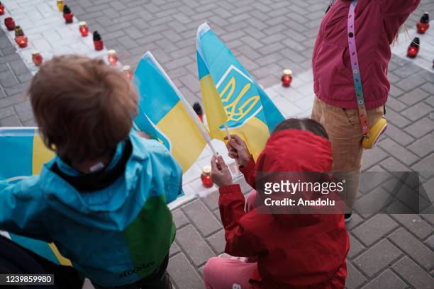 Children, holding Ukrainian flags, are seen during protest against Russian attacks on Ukraine in front of the National Opera and Ballet Theater in...