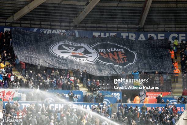 Giant banner celebrating the first ever double win against Cardiff City in 110 years is being moved by Swansea supporters in the east stand prior to...