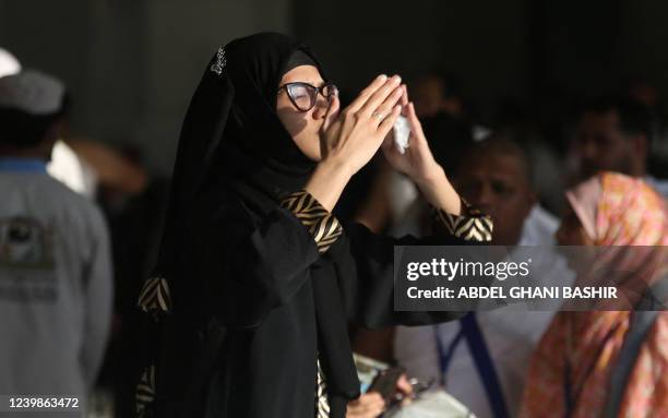 Muslim woman prays in front of the Kaaba, Islam's holiest shrine, at the Grand Mosque complex in the Saudi city of Mecca, during the holy fasting...