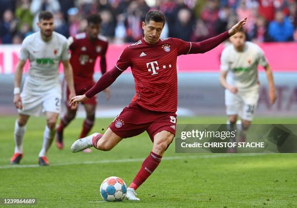 Bayern Munich's Polish forward Robert Lewandowski shoots to score a penalty during the German first division Bundesliga football match FC Bayern...