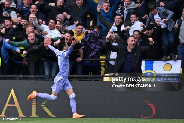 Leeds United's Brazilian-born Spanish striker Rodrigo celebrates in front of Leeds' supporters after scoring their second goal during the English...