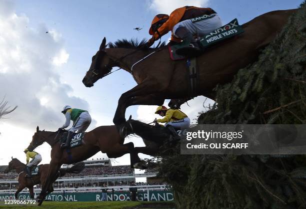 Eventual winner Noble Yeats ridden by jockey Sam Waley-Cohen take the water-jump during the Grand National Steeple Chase on the final day of the...