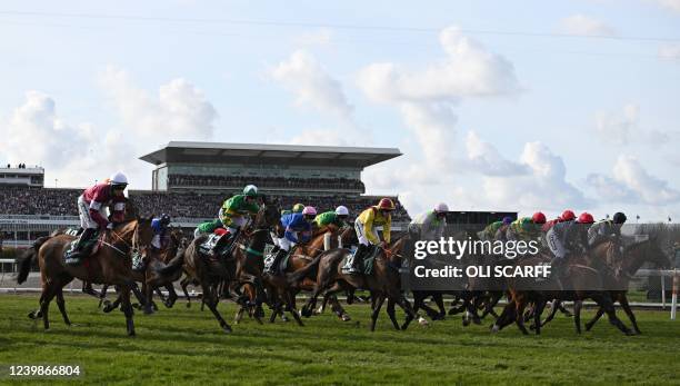 Horses race away from the start during the Grand National Steeple Chase on the final day of the Grand National Festival horse race meeting at Aintree...