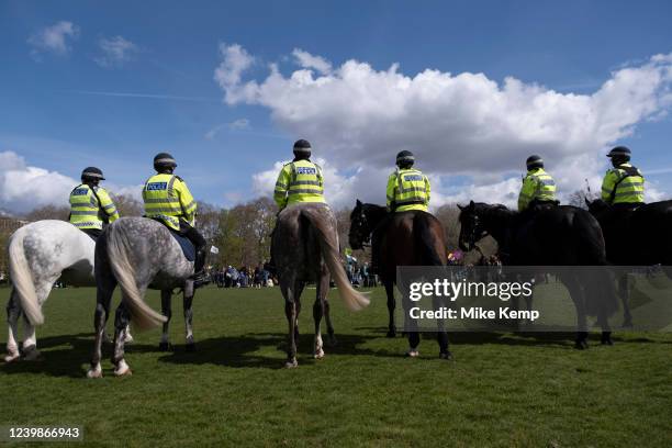 Mounted police stand back looking on as thousands of climate activists from Extinction Rebellion gathered in central London starting at Hyde Park for...