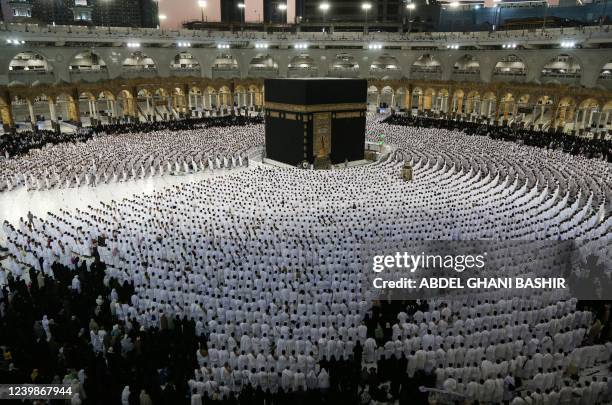 Muslims pray around the Kaaba, Islam's holiest shrine, at the Grand Mosque complex in the Saudi city of Mecca, during the fasting month of Ramadan,...