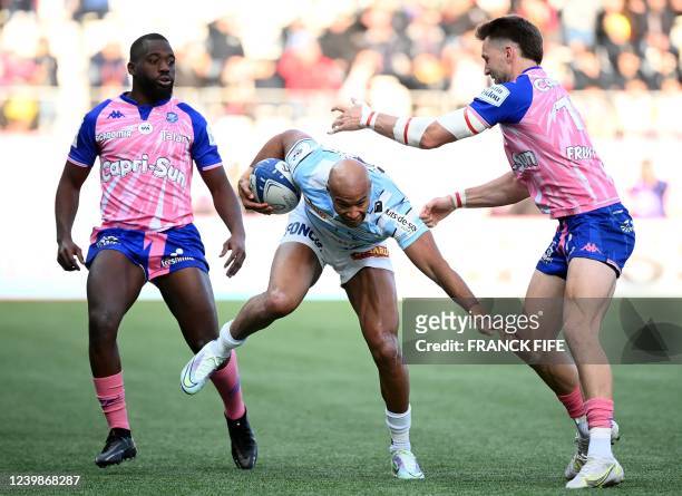 Racing92's French wing Teddy Thomas is challenged by Stade Francais' English centre Harry Glover during the European Rugby Champions Cup match...