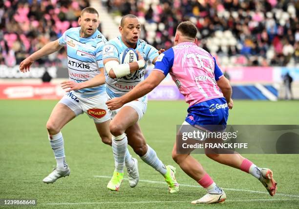 Racing's French centre Gael Fickou runs to scores a try next to Stade Francais' England right wing Harry Glover during the European Rugby Champions...