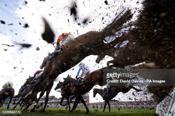 Runners and riders clear a fence during the Betway Handicap Chase on Grand National Day of the Randox Health Grand National Festival 2022 at Aintree...