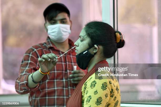 Health worker collects a swab sample for Covid-19 test, at District Hospital, Sector 30, on April 9, 2022 in Noida, India.