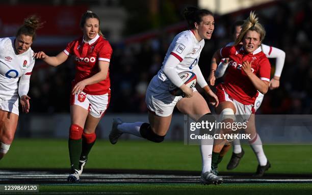 England's centre Emily Scarratt runs with the ball during the Six Nations international women's rugby union match between England and Wales at...