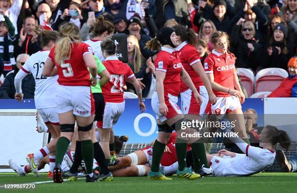 England's centre Emily Scarratt celebrates scoring a try during the Six Nations international women's rugby union match between England and Wales at...