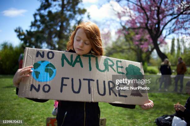 Girl holds a placard reading 'no nature, no future'. The day before the first round of the French presidential election, hundreds of collectives...