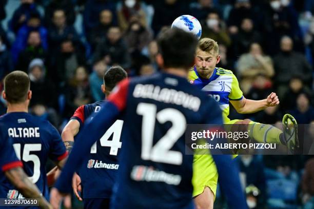 Juventus' Dutch defender Matthijs De Ligt scores his team's first goal during the Italian Serie A football match between Cagliari and Juventus at the...