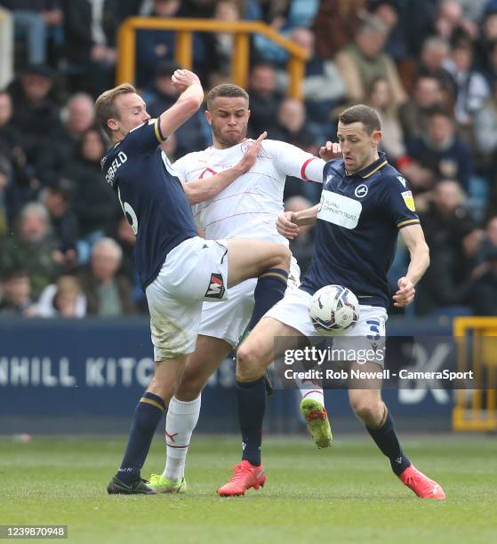 Barnsley's Carlton Morris challenges Millwall's Maikel Kieftenbeld and Murray Wallace during the Sky Bet Championship match between Millwall and...