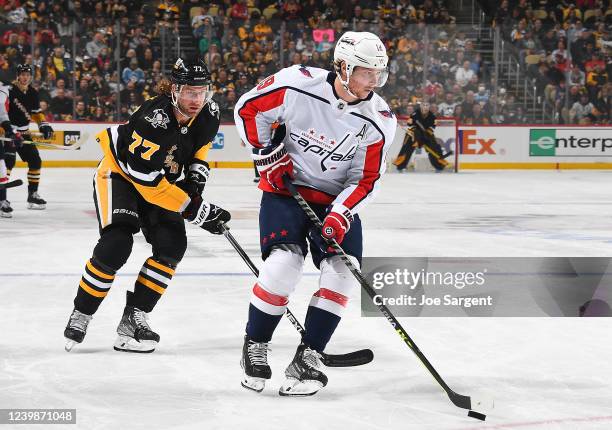 Nicklas Backstrom of the Washington Capitals moves the puck in front of Jeff Carter of the Pittsburgh Penguins in the first period during the game at...