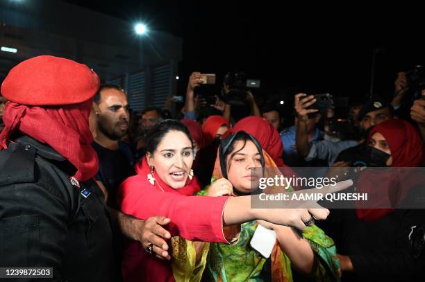Female police officer detain supporters of Pakistan Tehreek-e-Insaf party of dismissed Pakistan's prime minister Imran Khan outside the parliament...
