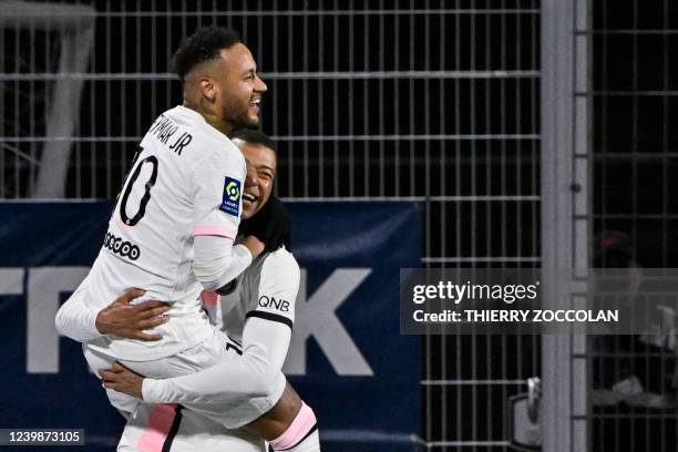 Paris Saint-Germain's Brazilian forward Neymar celebrates with Paris Saint-Germain's French forward Kylian Mbappe after scoring three goals during...