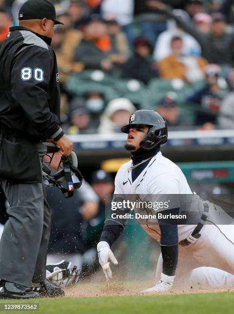 Javier Baez of the Detroit Tigers looks up at home plate umpire Adrian Johnson after being tagged out by pitcher Reynaldo Lopez of the Chicago White...