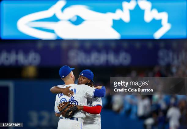 Vladimir Guerrero Jr. #27 and Matt Chapman of the Toronto Blue Jays hug after their MLB game victory over the Texas Rangers at Rogers Centre on April...