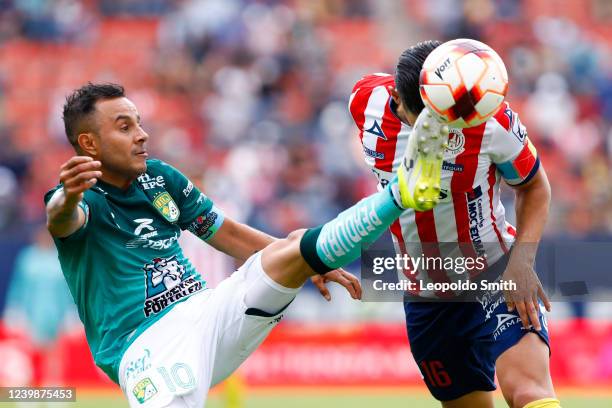 Luis Montes of Leon struggles for the ball with Javier Guemez of Atletico San Luis during the 13th round match between Atletico San Luis and Leon as...