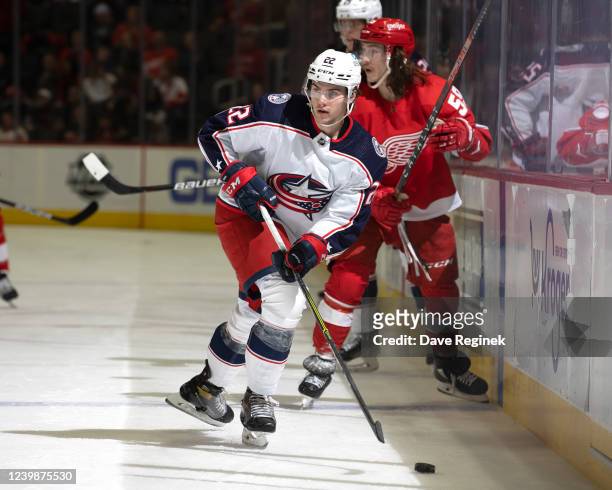 Jake Bean of the Columbus Blue Jackets handles the puck along the boards during the first period of an NHL game against the Detroit Red Wings at...