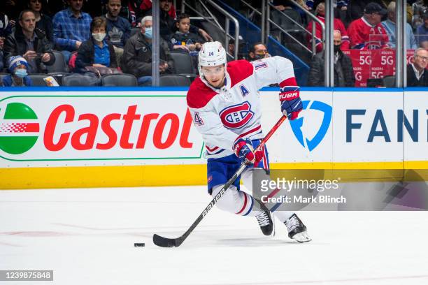 Nick Suzuki of the Montreal Canadiens plays the puck against the Toronto Maple Leafs during the first period at the Scotiabank Arena on April 9, 2022...