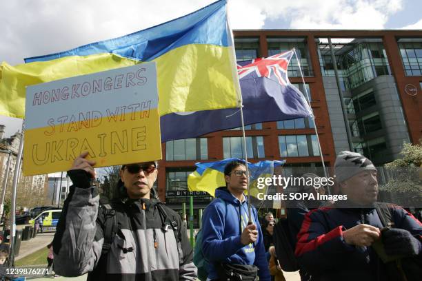 Member of Manchester's "Hong Kong" community, shows his and friends solidarity with Ukraine and its people during a highly vocal Protest March around...