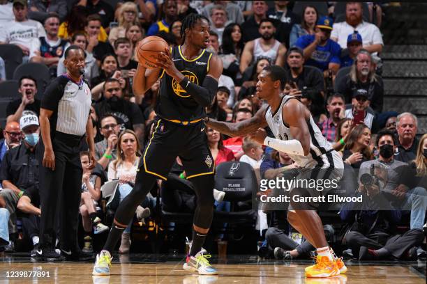 Lonnie Walker IV of the San Antonio Spurs plays defense on Jonathan Kuminga of the Golden State Warriors during the game on April 9, 2022 at the AT&T...