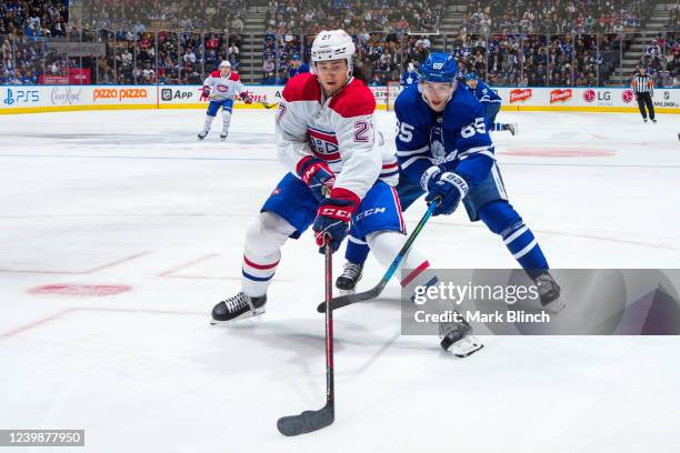 Alexander Romanov of the Montreal Canadiens plays the puck against Ilya Mikheyev of the Toronto Maple Leafs during the third period at the Scotiabank...