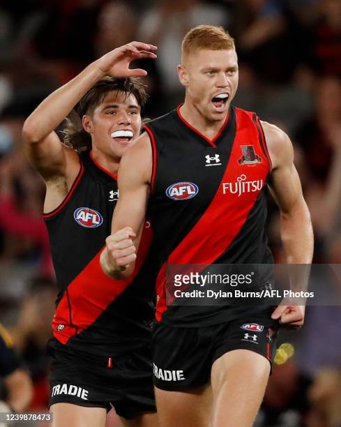Peter Wright of the Bombers celebrates a goal with Sam Durham of the Bombers during the 2022 AFL Round 04 match between the Essendon Bombers and the...