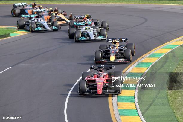 Ferrari's Monegasque driver Charles Leclerc leads a pack of cars at the start of the 2022 Formula One Australian Grand Prix at the Albert Park...