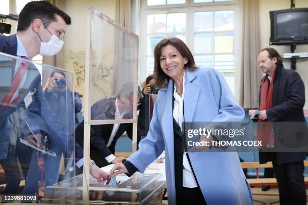 French Socialist Party presidential candidate Anne Hidalgo casts her ballot for the first round of France's presidential election at a polling...