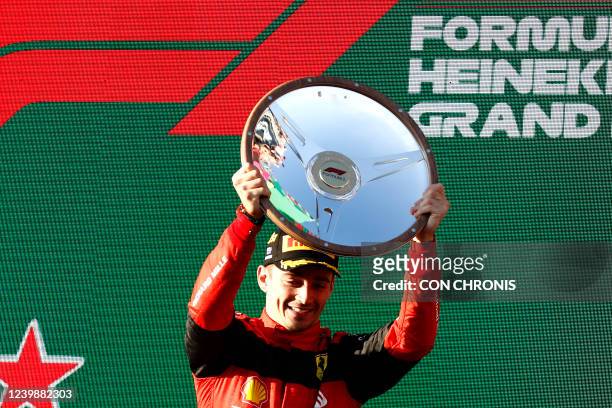 Ferrari's Monegasque driver Charles Leclerc celebrates his victory on the podium after the 2022 Formula One Australian Grand Prix at the Albert Park...