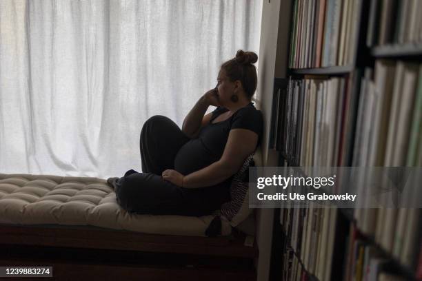 In this photo illustration a lonesome woman is sitting on a sofa on April 08, 2022 in Bonn, Germany.