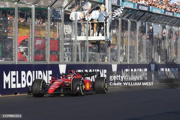 Ferrari's Monegasque driver Charles Leclerc crosses the finish line to win the 2022 Formula One Australian Grand Prix at the Albert Park Circuit in...