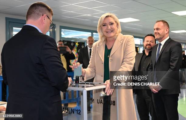 French far-right party Rassemblement National presidential candidate Marine Le Pen casts her ballot next to French far-right Rassemblement National...