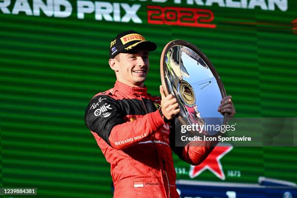 Race winner Charles Leclerc of Monaco and Scuderia Ferrari holds up his trophy on the podium at the Australian Formula One Grand Prix at Albert Park...