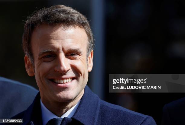 France's President and LREM party presidential candidate Emmanuel Macron looks on as he arrives ahead of casting his ballot for the first round of...