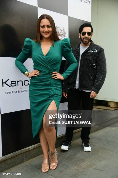 Bollywood actress Sonakshi Sinha with her brother Luv Sinha poses for pictures as she displays her artwork during her first exibition at the House of...