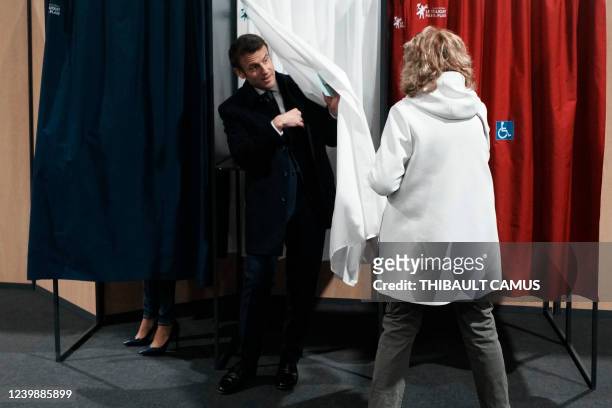 France's President and LREM party presidential candidate Emmanuel Macron leaves a booth as he prepares to cast his ballot for the first round of...