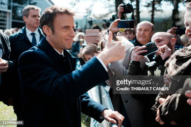 France's President and LREM party presidential candidate Emmanuel Macron thumbs up after voting for the first round of France's presidential election...
