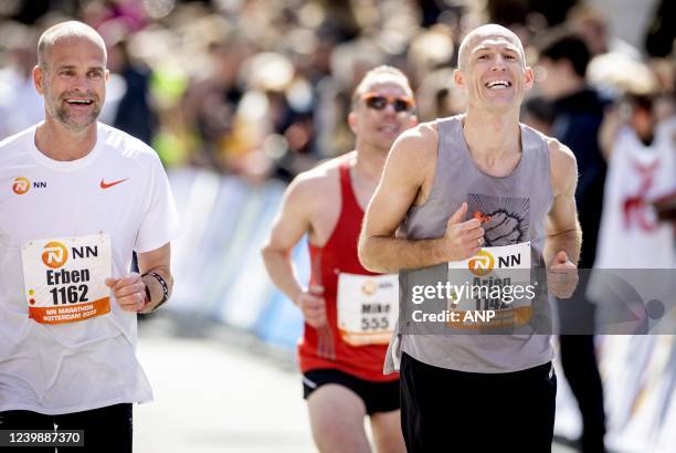 Former speed skater Erben Wennemars and former football player Arjen Robben cross the finish line together during the 41st edition of the NN Marathon...