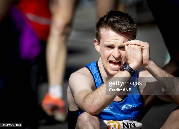 Runner crosses the finish line exhausted during the 41st edition of the NN Marathon Rotterdam on April 10, 2022 in Rotterdam, the Netherlands. KOEN...