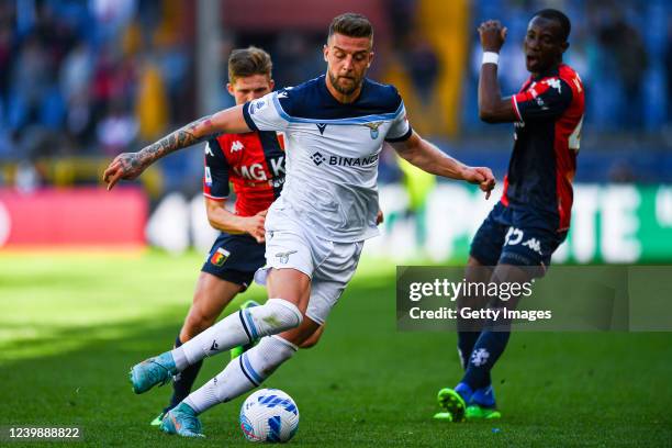 Sergej Milinkovic Savic of Lazio is seen in action controlled by Morten Frendrup and Kelvin Yeboah of Genoa during the Serie A match between Genoa...