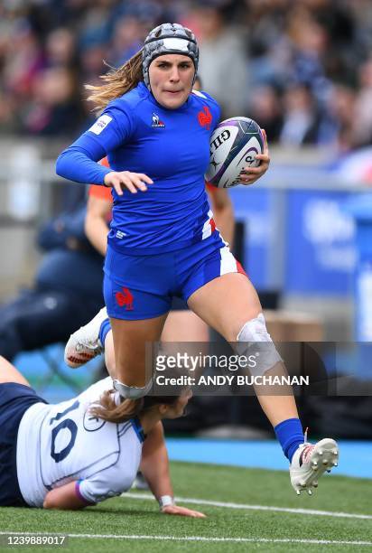 France's wing Melissande Llorens avoids a tackle from Scotland's fly-half Helen Nelson during the Six Nations international women's rugby union match...