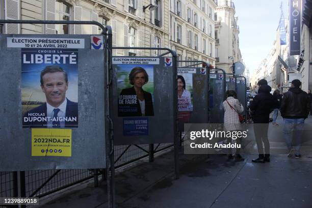 Election posters for the 2022 French presidential election are seen outside polling station, Roquepine Gymnasium as France goes to the polls in...